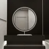 A modern bathroom vanity with a round LED mirror above a sink. Náhled obrázku produktu
