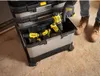 A person is placing a power drill into a rolling tool chest. Voir les images du produit
