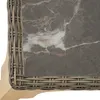 A close-up view of the corner of a table with a marble top and a woven rattan edge. Náhled obrázku produktu