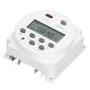 A white digital timer switch with a digital display and buttons. Voir les images du produit