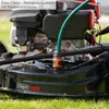 Close-up of a lawnmower with a hose attached for cleaning. Produktbild-Vorschau