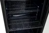 Interior of a black appliance with metal racks. Náhled obrázku produktu
