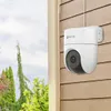A white dome security camera is mounted on a wooden-paneled wall, with greenery and sky visible in the background. Anteprima dell’immagine prodotto