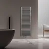 A modern bathroom with a dark bathtub, a towel radiator, and a chair. Produktbild-Vorschau