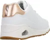 A side view of a white Skechers sneaker with rose gold accents. Náhled obrázku produktu