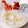 A close-up shot of ingredients and a hand mixer preparing a batter in a glass bowl. Produktbild-Vorschau