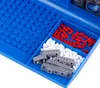A close-up view of a blue game board with compartments containing game pieces. Produktbild-Vorschau