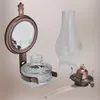 A collection of vintage oil lamp components, including a mirror, glass reservoir, burner, and chimney, arranged against a plain background. Podgląd zdjęcia produktu