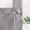A close-up view of a gray fabric curtain with a white string and a clear plastic rod inserted into a sleeve. Produktbild-Vorschau