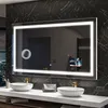 A modern bathroom vanity with a large illuminated mirror, two sinks, and gold faucets. Produktbild-Vorschau
