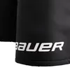 A close-up of black hockey pants with the Bauer logo printed in white. Náhled obrázku produktu