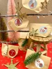A festive arrangement of DIY advent calendar bags with Christmas decorations. Produktbild-Vorschau