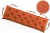 A long, tufted bench cushion in orange, shown on a white background. A circular inset shows a close-up of the fabric texture. Produktbild-Vorschau