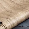 A close-up view of a roll of self-adhesive wood-effect wallpaper or flooring. Anteprima dell’immagine prodotto