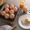 A breakfast scene with boiled eggs, juice, bread, and cheese. Náhľad obrázku produktu