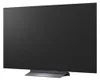 A black LG OLED evo television is shown from a side angle, resting on its stand. Podgląd zdjęcia produktu