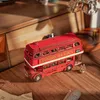 A wooden model of a red double-decker London tour bus sits on a wooden surface. Anteprima dell’immagine prodotto