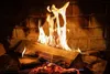 A close-up shot of a fire burning in a fireplace with logs and bricks visible. Produktbild-Vorschau