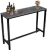 A bar table with bottles of alcohol and glasses on it. Podgląd zdjęcia produktu