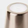 A close-up view of the top of a copper-colored LED table lamp. Podgląd zdjęcia produktu