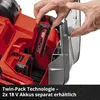 A person is inserting a battery into a red and black gardening tool. Produktbild-Vorschau