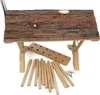 A wooden hay feeder with loose wooden dowels and a wooden board with holes, laid out on a white background. Produktbild-Vorschau