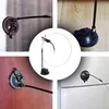 A collage of four images showing a cat toy with a suction cup base attached to different surfaces, and a central image of the toy itself. Voir les images du produit
