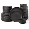 A set of black ceramic plates and bowls are neatly stacked against a white background. Náhľad obrázku produktu