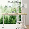 A standing desk in a modern office setting with a large window overlooking a forest. Produktbild-Vorschau