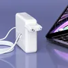 A white laptop charger and cable are placed next to an open laptop on a purple surface. Produktbild-Vorschau