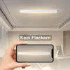 A modern LED ceiling light is shown mounted on a ceiling, with a smartphone displaying the same light in the foreground. Náhled obrázku produktu