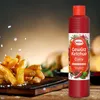 A bottle of Hela Gewürz Ketchup Curry is shown next to a pile of french fries. Produktbild-Vorschau
