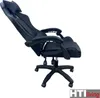 A black office chair with a headrest and footrest, shown from the side with the backrest reclined. Produktbild-Vorschau