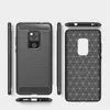 A dark gray TPU phone case with a carbon fiber texture is displayed from multiple angles against a light gray background. Produktbild-Vorschau