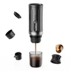 A portable coffee maker with its accessories, showing coffee being brewed into a cup. Produktbild-Vorschau