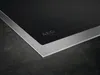 A close-up view of the corner of a black induction cooktop with a silver metal frame. Produktbild-Vorschau
