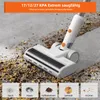 A white cordless vacuum cleaner is shown cleaning up debris from a floor. Four small inset images show different types of debris: dust, hair, coffee beans, and grains. Produktbild-Vorschau