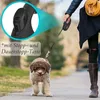 A person walking a dog on a leash outdoors. Produktbild-Vorschau