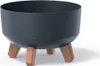 A dark speckled planter pot with three wooden legs, shown against a white background. Náhľad obrázku produktu