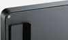 A close-up view of the corner of a dark gray mechanical keyboard, showing a hinge and a screw. Produktbild-Vorschau