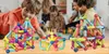 Children playing with magnetic building blocks in a room. Náhled obrázku produktu