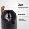 Close-up of the top of a dark-colored kettle, showing internal details and text labels indicating product features and safety information. Voir les images du produit