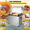 A 12-volt refrigerator is shown on a beach setting, with various food items and drinks displayed around it, suggesting its use for travel and outdoor activities. Produktbild-Vorschau
