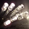 A close-up view of a string of white LED lights. Produktbild-Vorschau