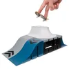 A finger is holding a miniature skateboard above a toy skate ramp. Náhľad obrázku produktu