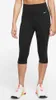 A person wearing black Nike capri leggings and white sneakers. Produktbild-Vorschau