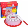 A toy wooden cake with a box in the background. Voir les images du produit