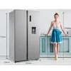 A woman stands next to a refrigerator in a kitchen setting, with dimensions indicated. Produktbild-Vorschau