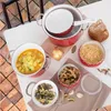 A collection of cookware and food items arranged on a table. Náhled obrázku produktu