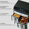 A close-up, angled view of a dual-chamber air fryer, with one chamber filled with french fries and the other with chicken wings. Text callouts highlight features. Produktbild-Vorschau